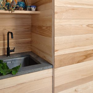 Hardwood Ash floor-to-ceiling pull-out Laundry Furniture Cupboards and Sink Unit designed and made by HOUT to create a fresh natural space to store all laundry equipment whilst providing perfect function.