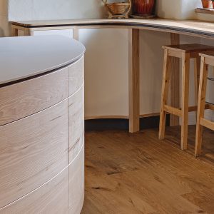 Contemporary highly bespoke solid wood Ash curved farmhouse kitchen designed and made in Cumbria by HOUT